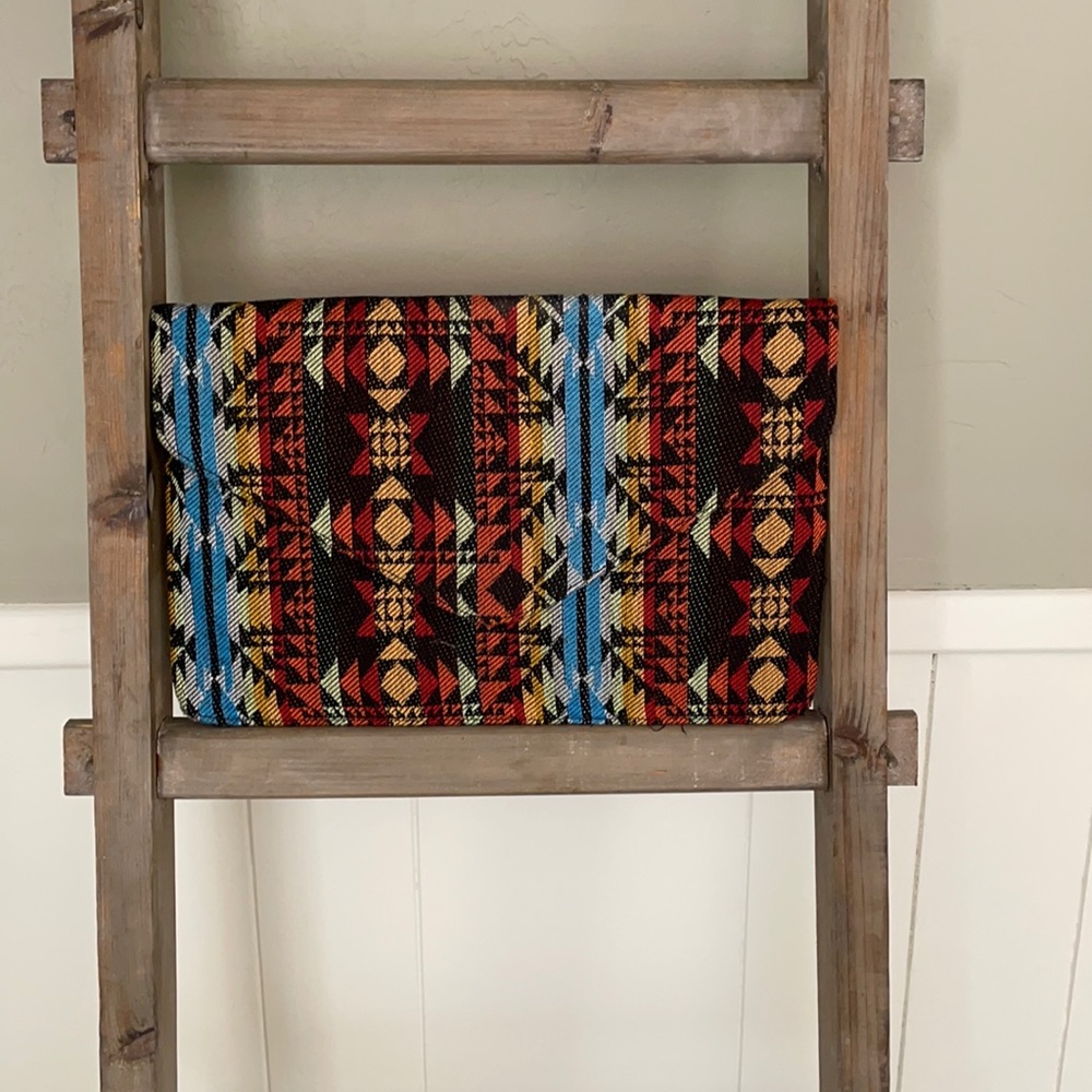 Large envelope clutch with Aztec design.